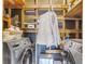 Convenient laundry room with modern washer and dryer units and storage shelves at 5028 Victoria Ave, North Charleston, SC 29405
