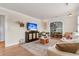 Spacious living room with hardwood floors, large windows and an arched opening to the dining room at 5028 Victoria Ave, North Charleston, SC 29405