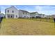 A spacious backyard with a black metal fence provides privacy and a clear view of the surrounding homes at 515 Purple Finch Rd, Summerville, SC 29486