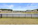 A tranquil backyard with a black metal fence offers picturesque views of a serene lake and surrounding neighborhood at 515 Purple Finch Rd, Summerville, SC 29486