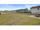 The backyard features a well-maintained lawn, a black metal fence, and outdoor seating on a concrete patio at 515 Purple Finch Rd, Summerville, SC 29486