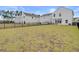 The expansive backyard features a black metal fence for privacy and ample room for outdoor activities at 515 Purple Finch Rd, Summerville, SC 29486