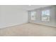 Bright bedroom features neutral carpet, walls, and plenty of natural light from the two windows at 515 Purple Finch Rd, Summerville, SC 29486