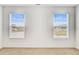 Bright bedroom featuring two windows with a neighborhood view and neutral carpet at 515 Purple Finch Rd, Summerville, SC 29486
