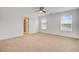 Spacious bedroom boasts plush carpeting, neutral paint, ceiling fan, and abundant natural light at 515 Purple Finch Rd, Summerville, SC 29486