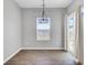 Light-filled dining area features luxury vinyl plank flooring, contemporary lighting fixture, and sliding glass doors at 515 Purple Finch Rd, Summerville, SC 29486