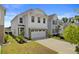 The home's front exterior features a two-car garage, beautiful landscaping, and a pristine driveway at 515 Purple Finch Rd, Summerville, SC 29486