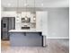 Modern kitchen with stainless appliances, island with sink, pendant lights, and ample storage at 515 Purple Finch Rd, Summerville, SC 29486
