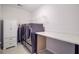 Well-organized laundry room boasts washer, dryer, folding table, and ample storage space at 515 Purple Finch Rd, Summerville, SC 29486
