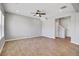 Spacious living room with neutral tones, wood-look flooring, ceiling fan and ample natural light at 515 Purple Finch Rd, Summerville, SC 29486