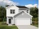 Two-story home featuring a two-car garage, neat landscaping, and modern architectural details at 5304 Bending Flats Way, Summerville, SC 29485