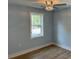 Bright bedroom with fresh paint, ceiling fan, and large window providing ample natural light at 5513 Blackwell Ave # A, North Charleston, SC 29406