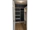 Open walk-in closet features built-in shelving and ample hanging space with painted walls at 5513 Blackwell Ave # A, North Charleston, SC 29406