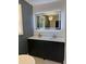 Modern bathroom with double vanity, illuminated mirror, quartz countertops, and dark wood cabinets at 5513 Blackwell Ave # B, North Charleston, SC 29406
