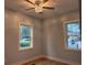 Cozy bedroom with a modern ceiling fan, new floors, and plenty of natural light from two windows at 5513 Blackwell Ave # B, North Charleston, SC 29406