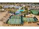 Expansive aerial view of the community, highlighting tennis courts, pool, clubhouse, and well-maintained landscaping at 6016 Wild Azalea Rd, Summerville, SC 29483