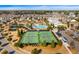 Beautiful aerial view of the community showcasing tennis courts, a pool, clubhouse, and surrounding homes at 6016 Wild Azalea Rd, Summerville, SC 29483