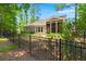 Cozy home featuring a fenced backyard, screened-in porch, and a well-maintained lawn with mature trees at 6016 Wild Azalea Rd, Summerville, SC 29483