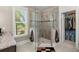 Bright bathroom featuring a glass shower, a large window and walk-in closet at 6016 Wild Azalea Rd, Summerville, SC 29483