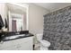 Bathroom featuring a sink and vanity with a black countertop, toilet, and shower with a zebra print curtain at 6016 Wild Azalea Rd, Summerville, SC 29483