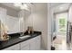 Bathroom featuring a sink and vanity with a black countertop and a full shower behind a shower curtain at 6016 Wild Azalea Rd, Summerville, SC 29483