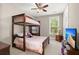 Bright bedroom with a bunk bed, side table, and window allowing in natural light for a cozy feel at 6016 Wild Azalea Rd, Summerville, SC 29483