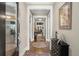 A welcoming foyer featuring hardwood floors, neutral walls, and views of the dining room at 6016 Wild Azalea Rd, Summerville, SC 29483