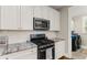 Modern kitchen with stainless steel appliances, and an adjoining laundry room at 6016 Wild Azalea Rd, Summerville, SC 29483