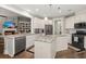 Spacious kitchen with a large island, stainless appliances, and seamless flow to living area at 6016 Wild Azalea Rd, Summerville, SC 29483