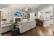 Bright and cozy living room showcasing a fireplace, open layout, and hardwood floors at 6016 Wild Azalea Rd, Summerville, SC 29483