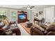 Spacious living room with two leather sofas, a large rug, and built-in shelves for a luxurious feel at 6016 Wild Azalea Rd, Summerville, SC 29483