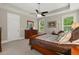 Bright main bedroom featuring a king-sized bed, a dresser and large windows at 6016 Wild Azalea Rd, Summerville, SC 29483