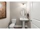 A well-lit powder room featuring a pedestal sink, oval mirror, and a classic design at 6016 Wild Azalea Rd, Summerville, SC 29483