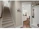 Carpeted staircase leading to the second level, offering a glimpse into the open kitchen at 6016 Wild Azalea Rd, Summerville, SC 29483