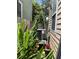 Backyard area with AC unit, surrounded by lush greenery and potted plants at 7 Dingle St, Charleston, SC 29403