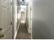 Hallway with neutral gray walls, contrasting white trim, doors and wood-look floor at 7 Dingle St, Charleston, SC 29403
