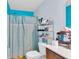 Cozy bathroom with blue walls, a shower with curtain, and a toilet at 7644 High Maple Cir, North Charleston, SC 29418