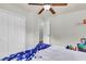 Bedroom with ceiling fan, closet with double doors, and white walls at 7644 High Maple Cir, North Charleston, SC 29418