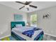 Bedroom with teal bedframe, ceiling fan, and plenty of natural light from the window at 7644 High Maple Cir, North Charleston, SC 29418