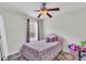Bright bedroom featuring a ceiling fan, purple accents, and a plush area rug at 7644 High Maple Cir, North Charleston, SC 29418