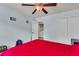 Bedroom featuring a ceiling fan and a door to the utility room at 7644 High Maple Cir, North Charleston, SC 29418