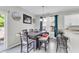 Bright dining area with stylish seating, modern decor, and easy access to the kitchen and outdoor patio at 7644 High Maple Cir, North Charleston, SC 29418