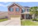 Charming two-story brick home with a two-car garage, manicured lawn, and a welcoming front porch at 7644 High Maple Cir, North Charleston, SC 29418