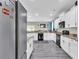 Well-lit kitchen showcases white cabinetry, granite countertops, stainless steel appliances, and luxury vinyl flooring at 7644 High Maple Cir, North Charleston, SC 29418