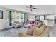 Open floorplan with bright living room leading to dining area and kitchen with large windows at 7644 High Maple Cir, North Charleston, SC 29418