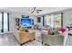 Bright and inviting living room with gray wood floors, a fireplace, and a large screen television at 7644 High Maple Cir, North Charleston, SC 29418