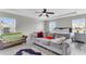 Bright primary bedroom featuring a ceiling fan, and large windows at 7644 High Maple Cir, North Charleston, SC 29418