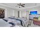 Spacious primary bedroom featuring a tray ceiling, ceiling fan and connecting ensuite bath at 7644 High Maple Cir, North Charleston, SC 29418