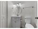 Bright bathroom featuring a white vanity with storage, a round mirror, and modern fixtures providing everyday comfort at 7950 Parklane Ct # C, North Charleston, SC 29418