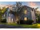 Charming condo featuring mature landscaping, a chimney, and beautiful sunset lighting at 7950 Parklane Ct # C, North Charleston, SC 29418